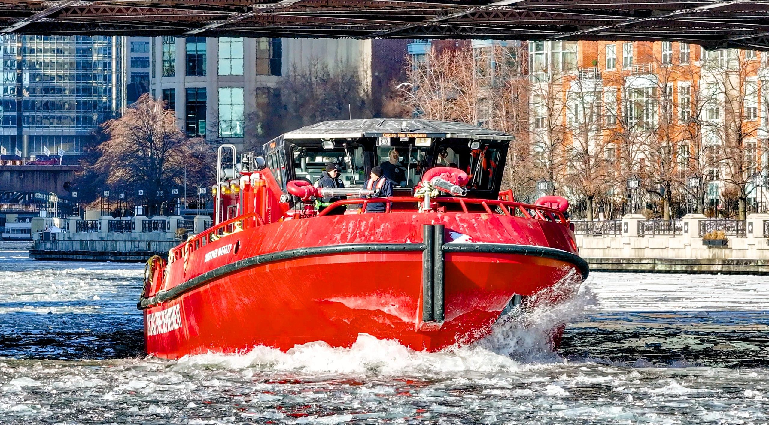 Red boat navigating icy river