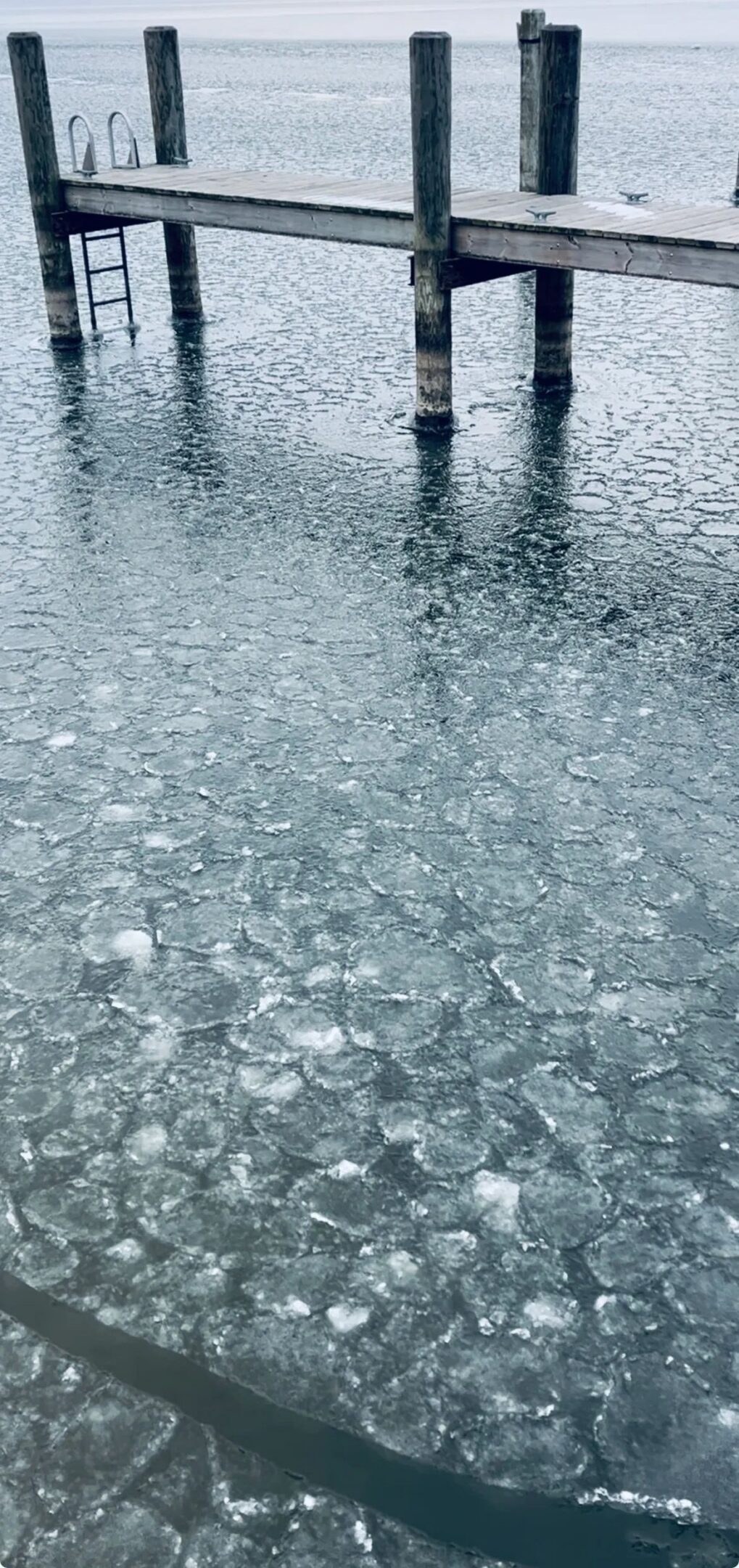 Frozen lake with wooden pier