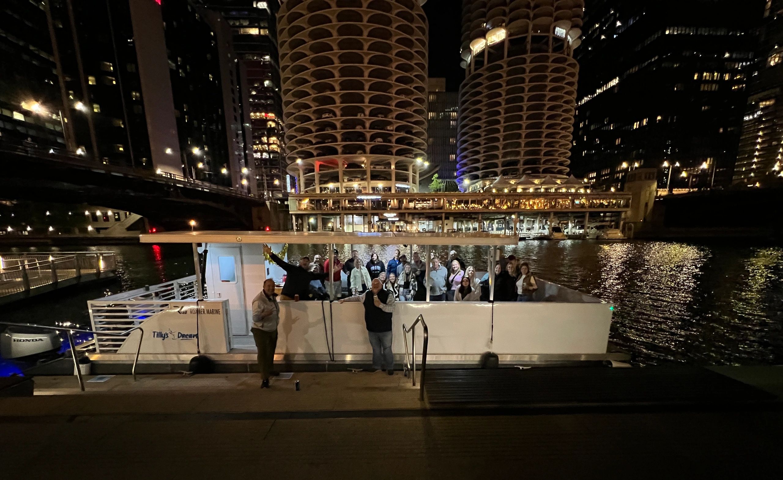 Boat docked by illuminated skyscrapers