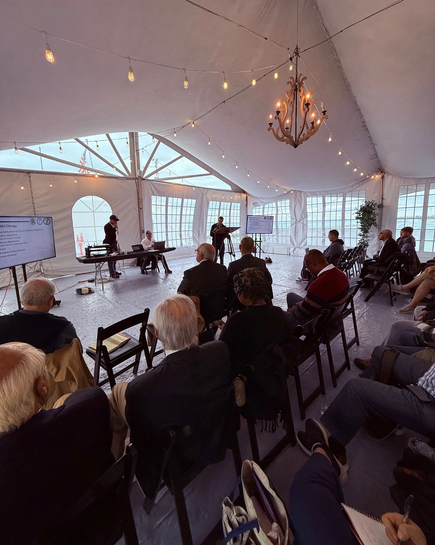 Audience attending a conference in a tent