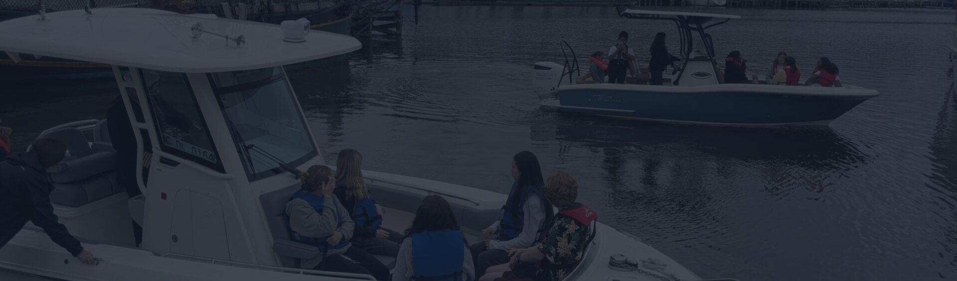 Two boats with passengers in harbor