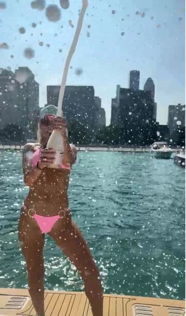 Popping Champagne for a Champagne Shower (But don't drink it! Stay sober!)/Photo courtesy of Boat Safe Chicago pink bikini girl in pink bikini popping champagen in the chicago playpen boating charter charterboat boating Popping Champagne for a Champagne Shower (But don't drink it! Stay sober!)/Photo courtesy of Boat Safe Chicago pink bikini girl in pink bikini popping champagen in the chicago playpen boating charter charterboat boating