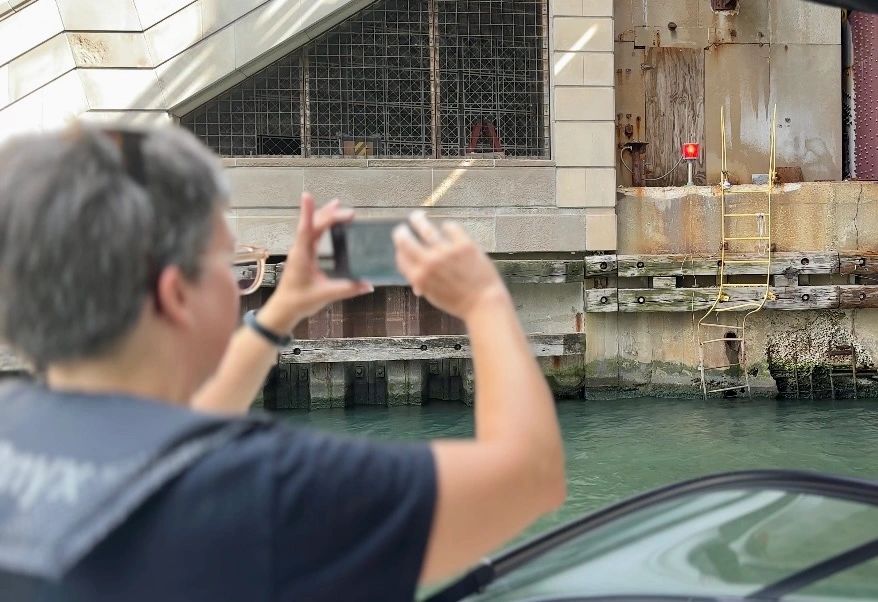 Tourist taking photo of urban canal area