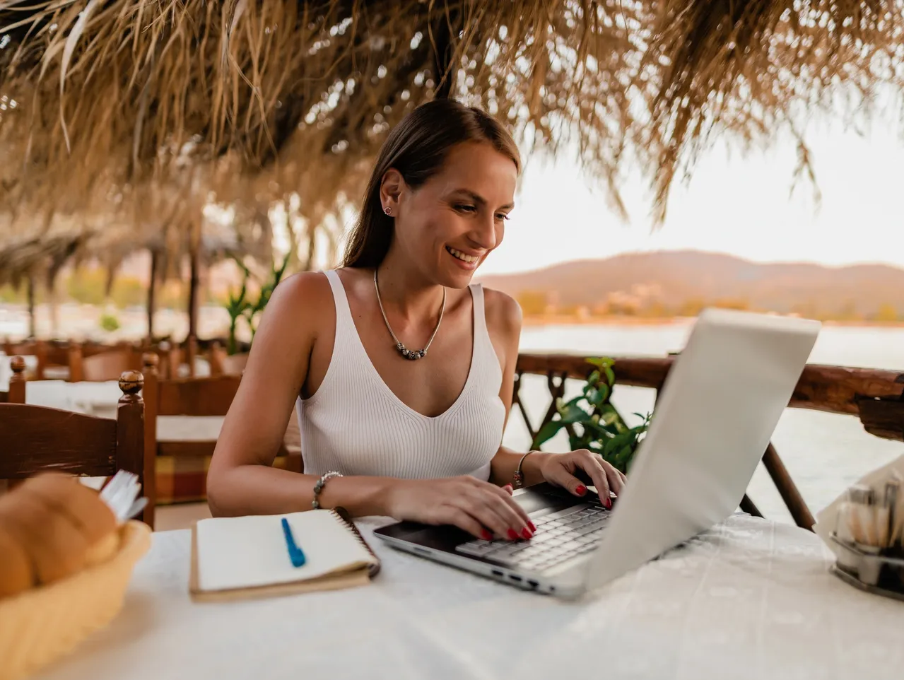 Smiling woman using laptop outdoors