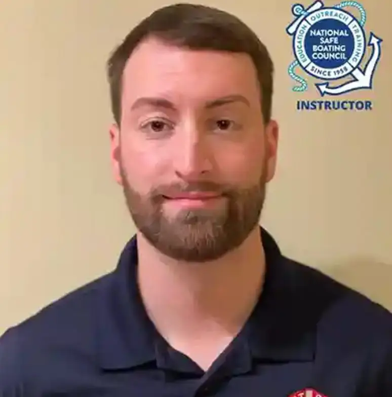 Man with a beard wearing a shirt, at the camera