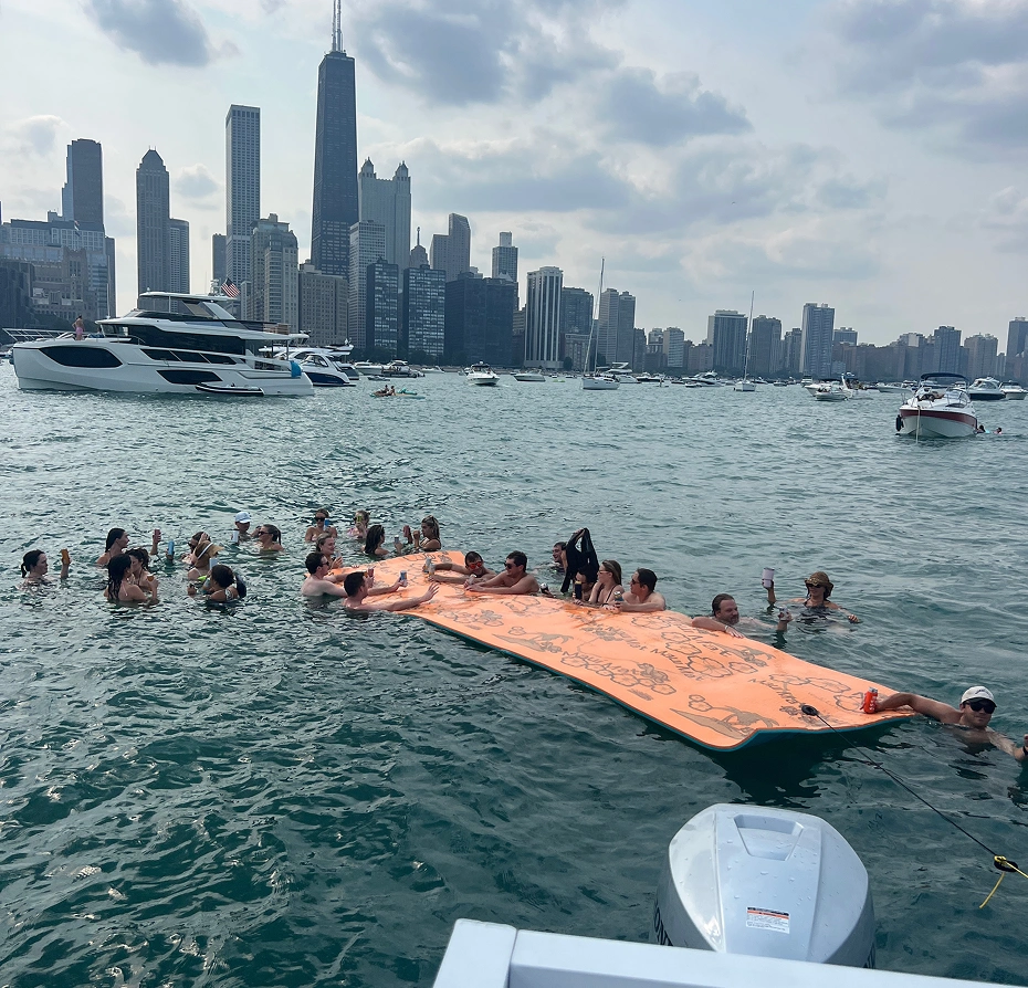 Group of people swimming in the water near a boat