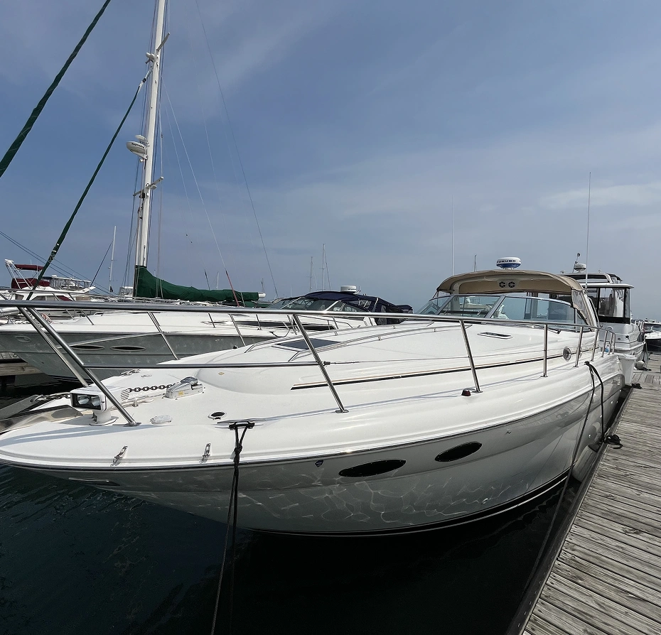 340 Sundancer motor boat docked at a wooden bridge on the right side of the image