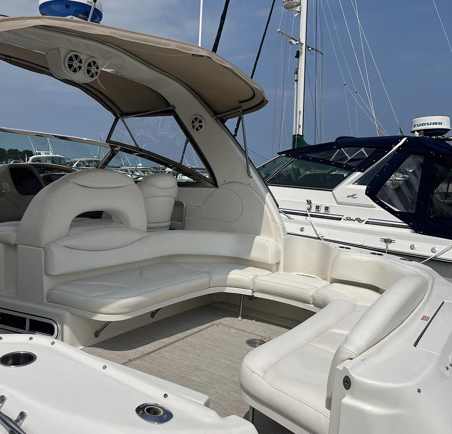 340 Sundancer motor boat with a cockpit featuring a seating area, surrounded by other boats in the background