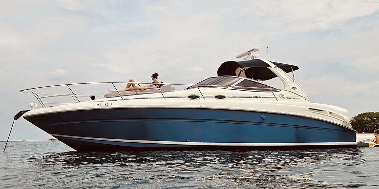 Woman sitting on a 340 Sundancer motor boat on the water