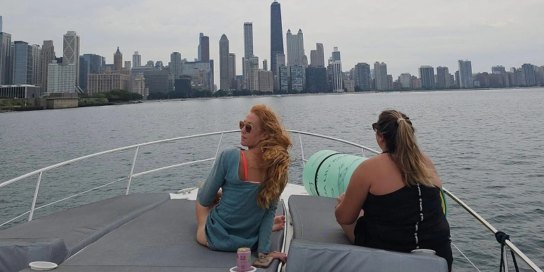 Two women sitting on the deck of a boat, enjoying a boat ride in boat