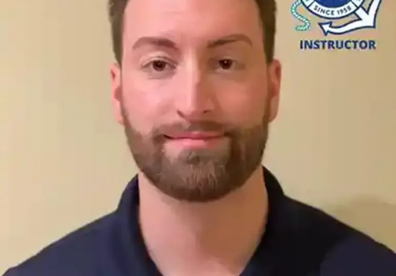 Man with a beard wearing a shirt, at the camera