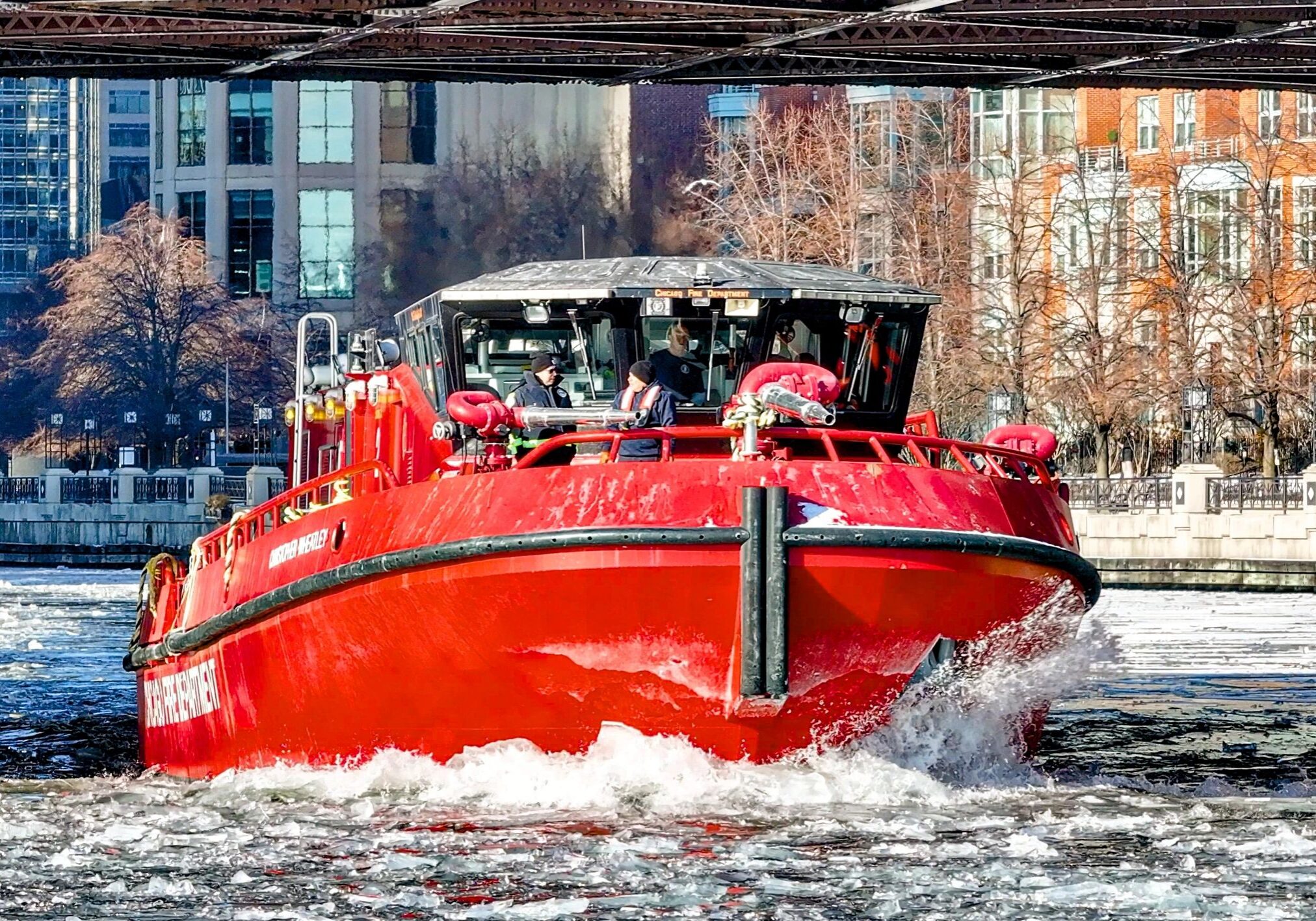 Red boat navigating icy river