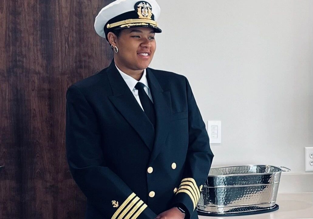 Uniformed individual beside a countertop