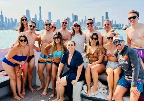 Friends posing on a boat in swimsuits