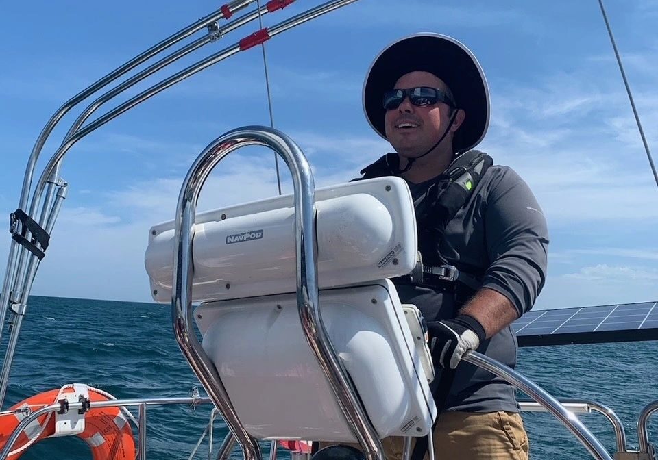 Sailor enjoying sunny day at sea