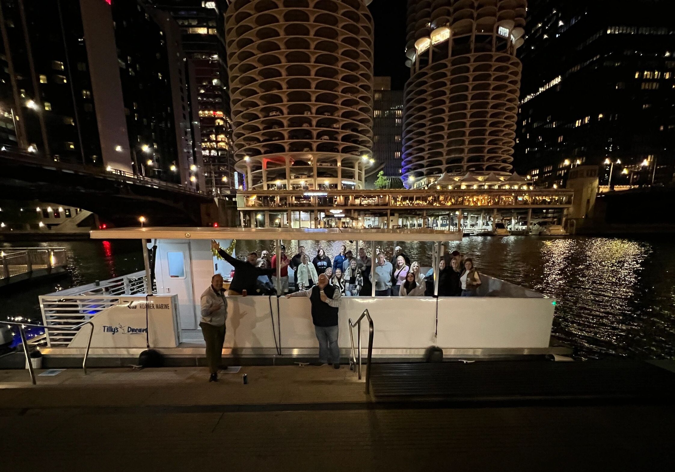 Boat docked by illuminated skyscrapers