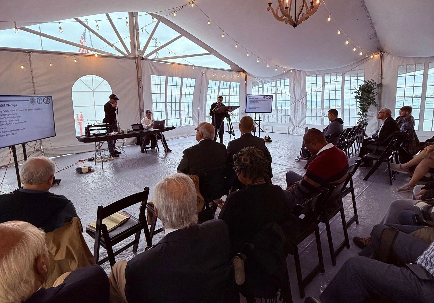 Audience attending a conference in a tent