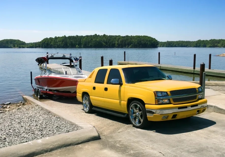 Vehicle launching boat into lake