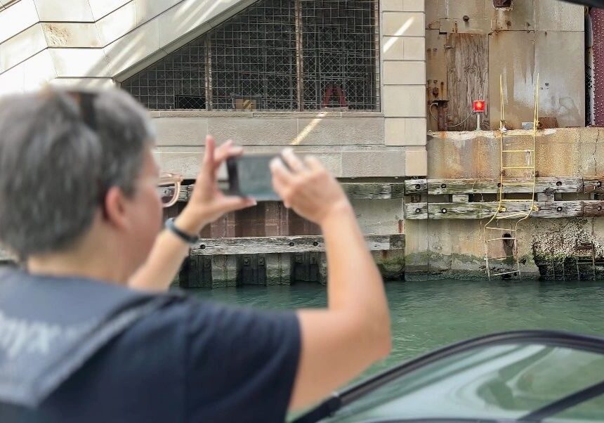 Tourist taking photo of urban canal area