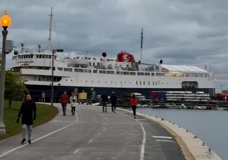Cruise ship docked beside a waterfront walkway